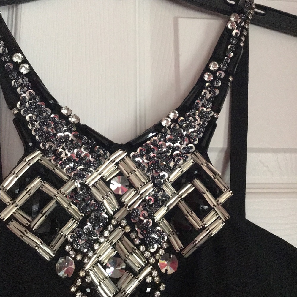 Black halter dress with silver embellishments.